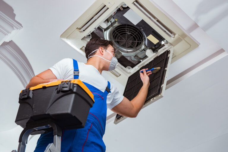 Worker,Repairing,Ceiling,Air,Conditioning,Unit