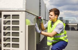 Professional HVAC technician servicing a commercial rooftop HVAC unit